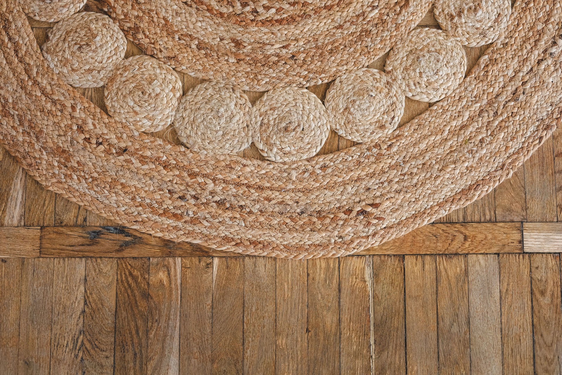 Natural woven rug on wooden floor showcasing craftsmanship and texture
