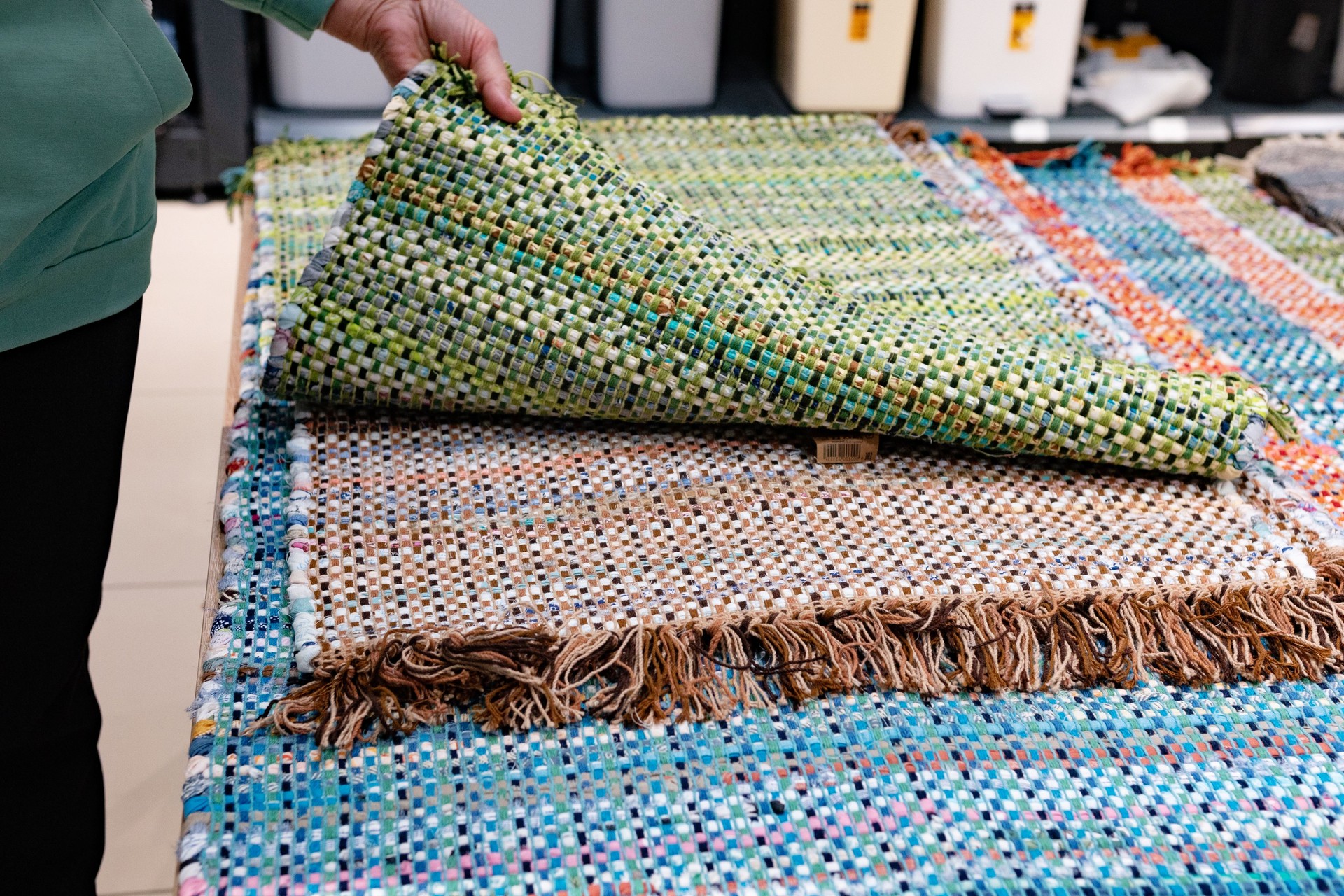 A woven rug made of old things. Eco-friendly development. Reuse of items. Handmade work.
